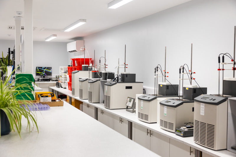 Laboratory setting with equipment and a desk.