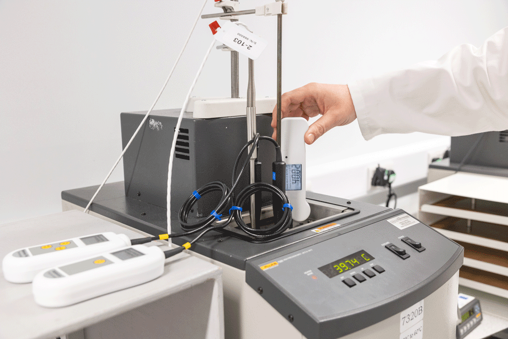 Laboratory setting with a person using a device on a table.
