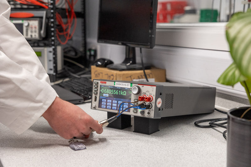 Person working with electronic equipment in a lab setting