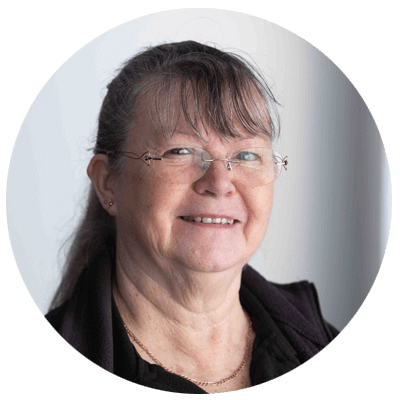 Person wearing glasses with a plain background