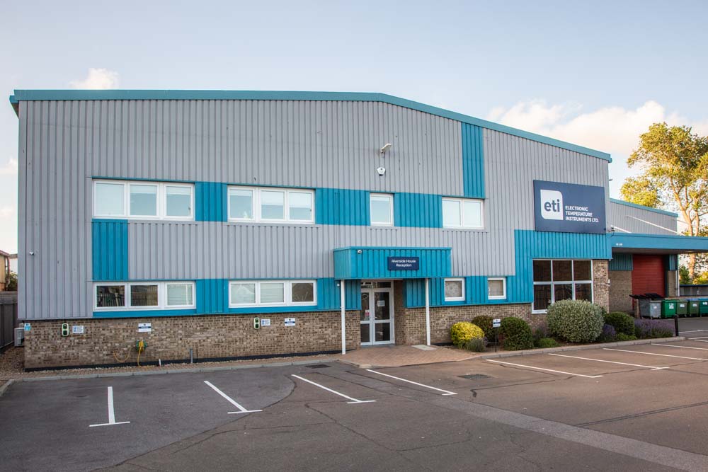 Commercial building with blue and gray facade, ETI logo visible