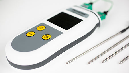 Digital thermometer with a probe on a white background
