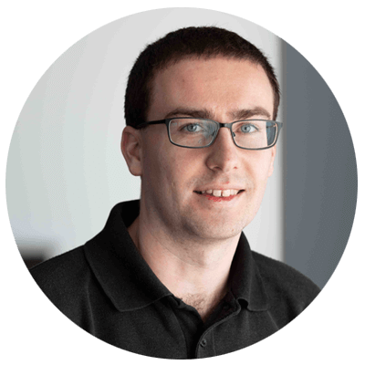 Portrait of Nathan the Repair Technician​, short dark hair, smiling with glasses on