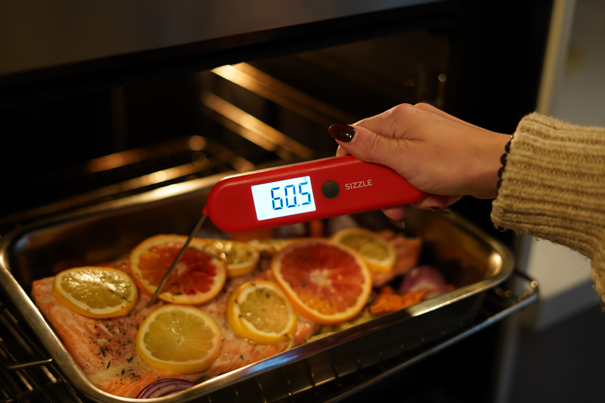 Sizzle Meat Thermometer testing the temperature of baked salmon